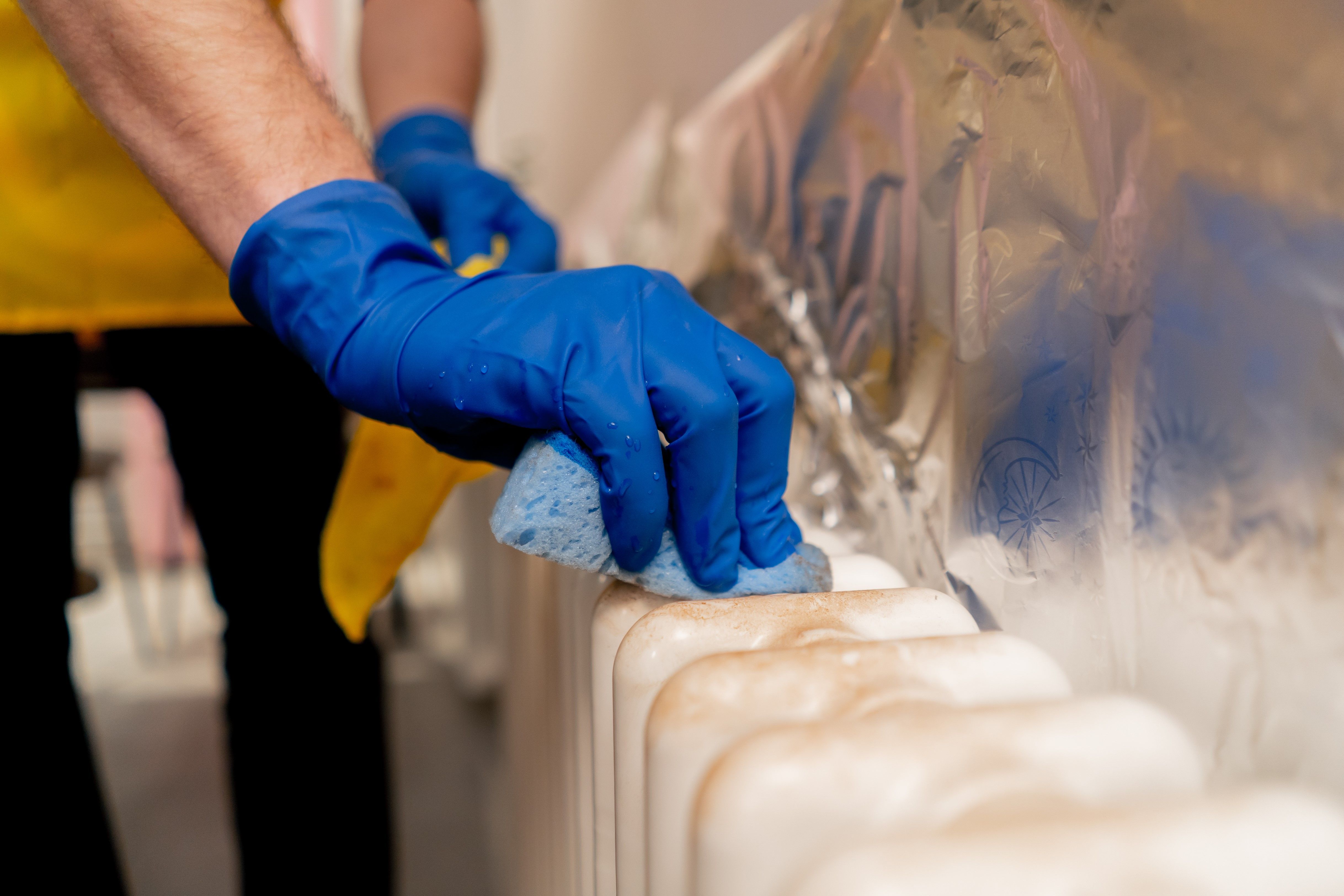 close-up-in-an-apartment-cleaner-in-a-yellow-apron-2024-12-02-03-58-00-utc